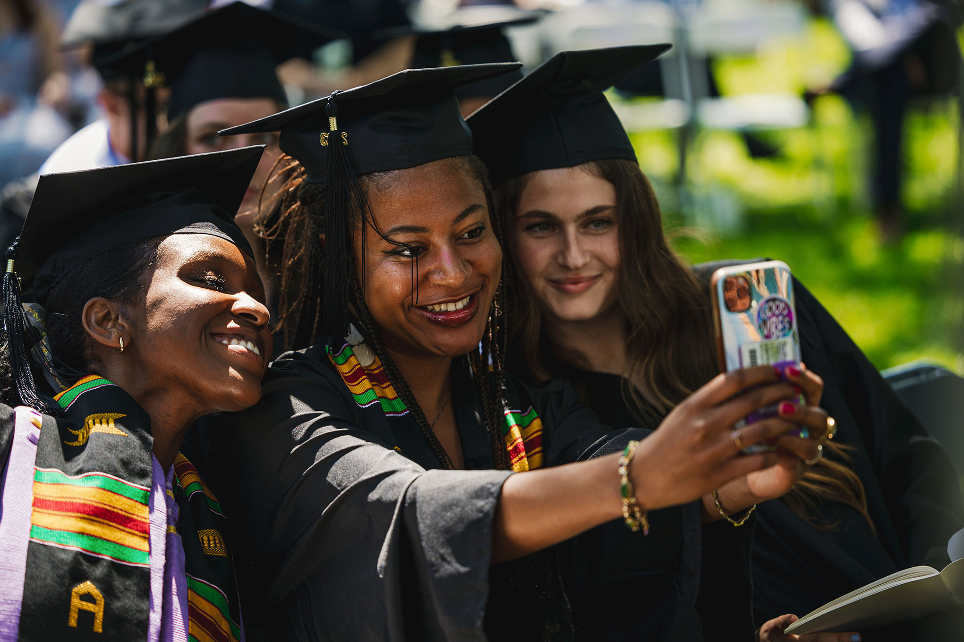 Three students take a selfie together.