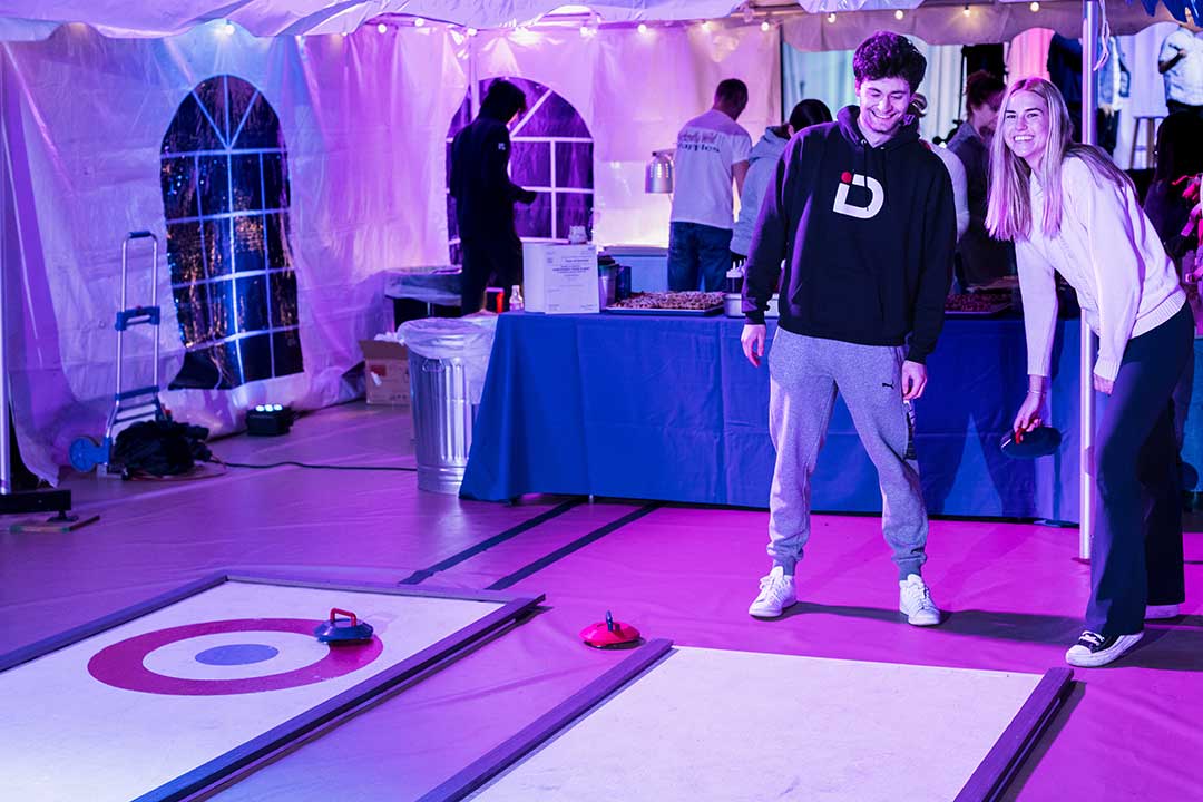 Two students play a game of curling.
