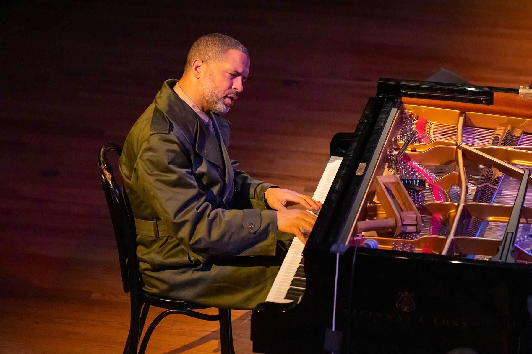 Jason Moran playing the piano during a concert.