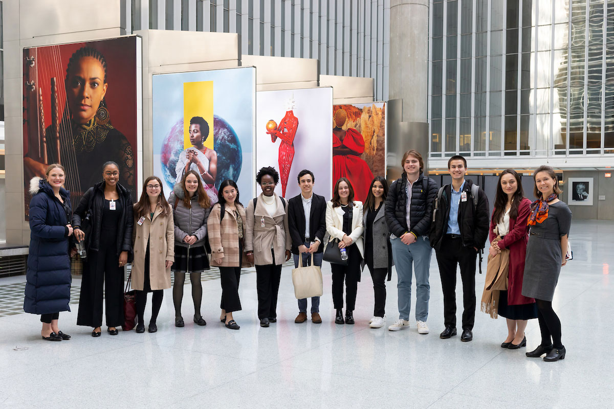 Amherst students pose for a photo in front of artwork displayed inside the World Bank.